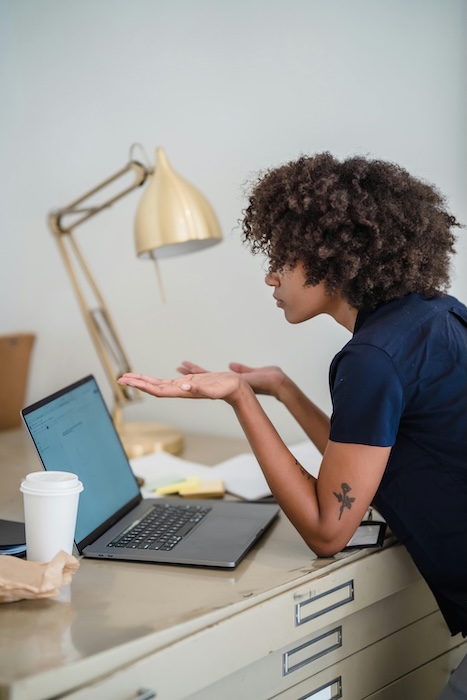 Confused woman staring at her computer 