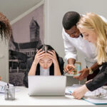 group looking at a computer confused